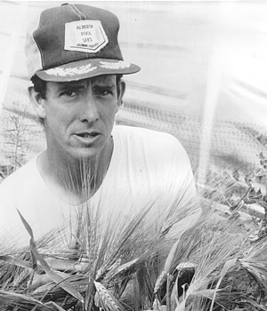 Bart Hall in one of his hull-less barley breeding plots in 1985. Photo courtesy of Bart Hall.