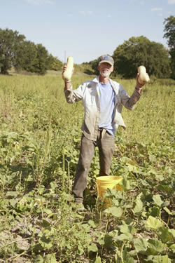 Jim Rowh holds two butternut squash 