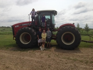 Faith, Thomas, Ward, Jacquelin, Matt and Rosco the dog with the Hoculak's 2014 Versatile 450 tractor.